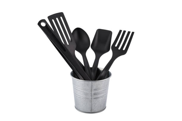 istock black plastic kitchen set skimmer, spade of frying pan in metal box isolate white 824642292