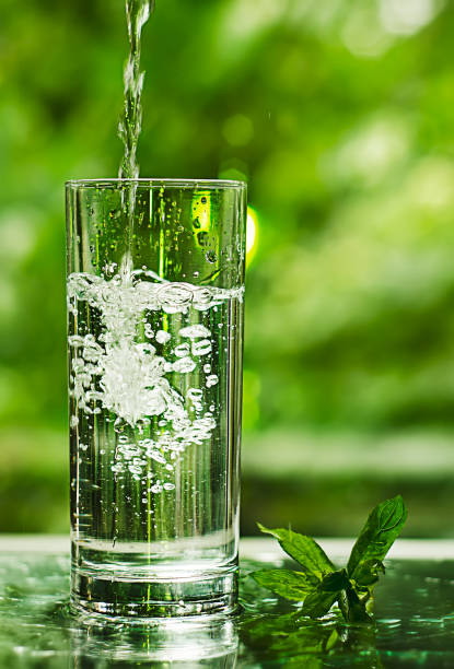 istock Cool fresh water with ice and mint. Splash in glass 824645878