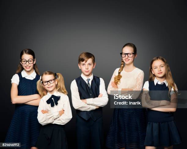 School Children Group Girls And Boy Students In Uniform Over Black Background Stock Photo - Download Image Now