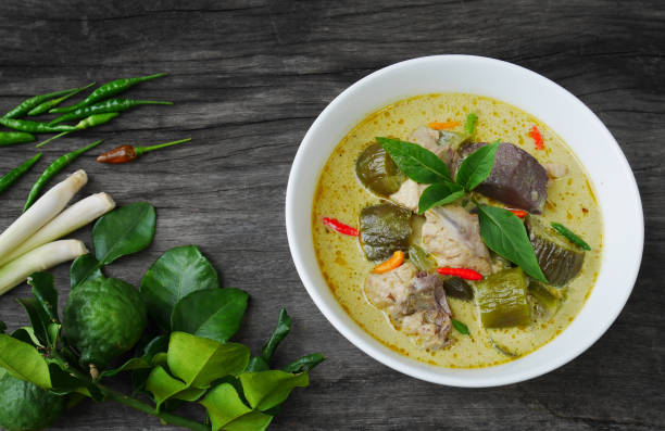 istock Thai Chicken green curry in white bowl on  the table with Thai herb 824649456