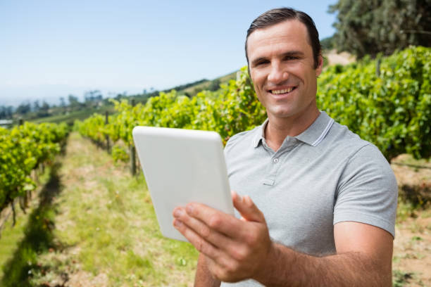 istock Portrait of vintner using digital tablet in vineyard 824652152