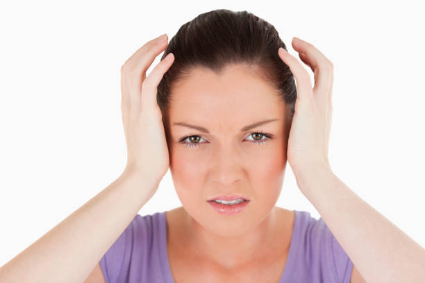 istock Portrait of a good looking woman having a headache while standing 824652524