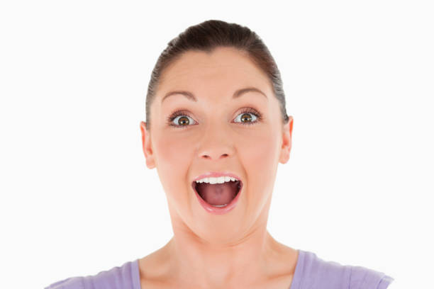 Portrait of a joyful woman posing while standing against a white background
