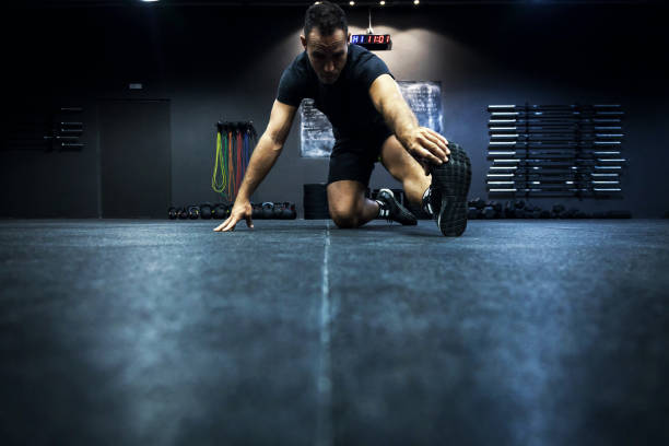 istock Gym fitness - Men stretching legs 824654376