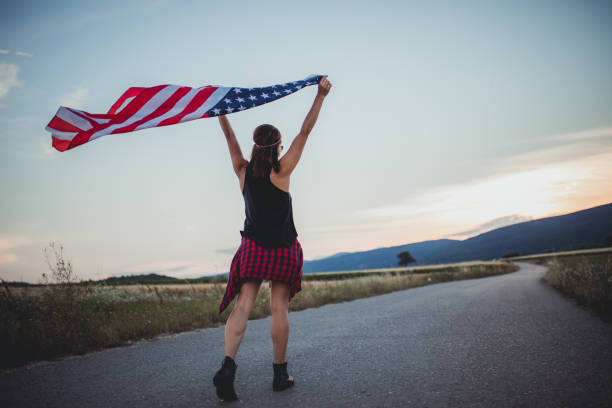 istock Woman walking with US flag 824656286