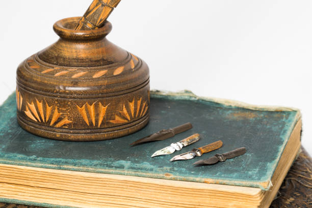 istock wooding ink pot with old books 824656614