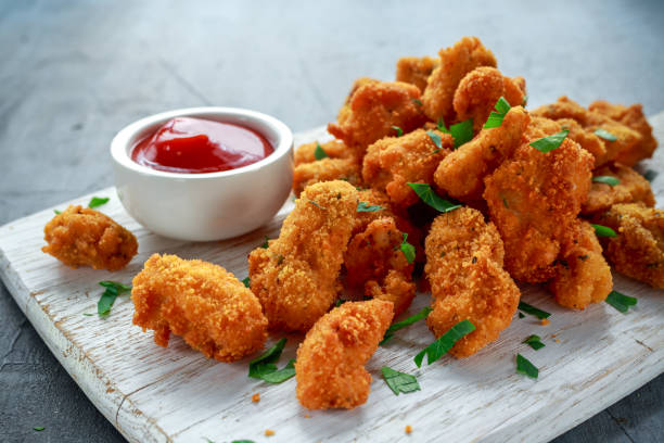 gebratene knusprige chicken nuggets mit ketchup auf tafel - schnelle suppen stock-fotos und bilder