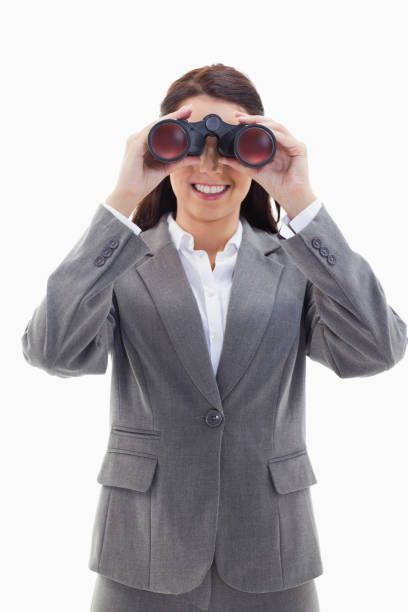 istock Smiling businesswoman looking through binoculars 824666578