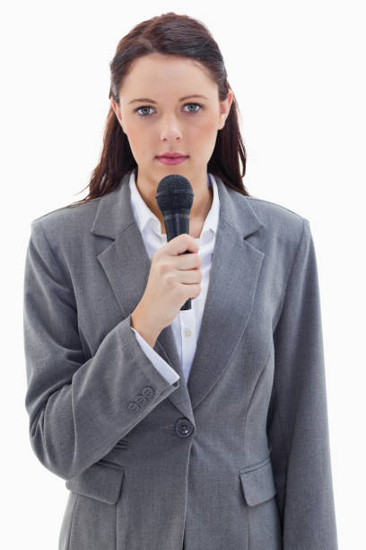 istock Serious businesswoman with a microphone 824666616