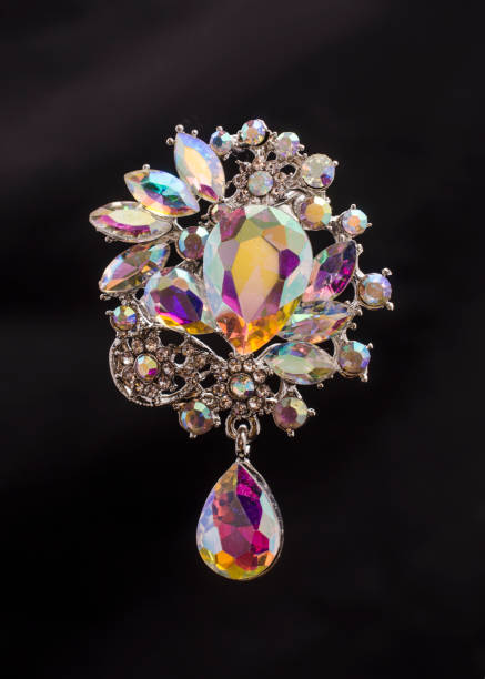 istock Brooch with colored crystals isolated on black 824667592