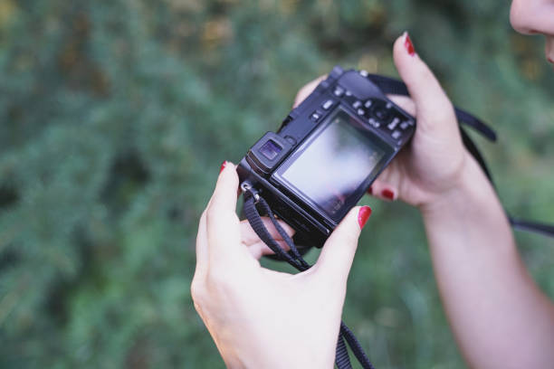 istock Young woman holding camera 824671794