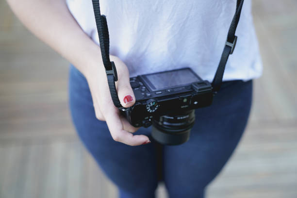 istock Young woman holding camera 824672166