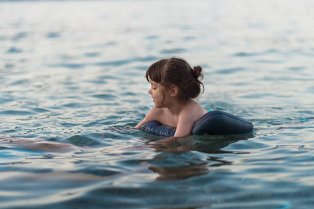 istock Young child swimming at the sea. 824673562