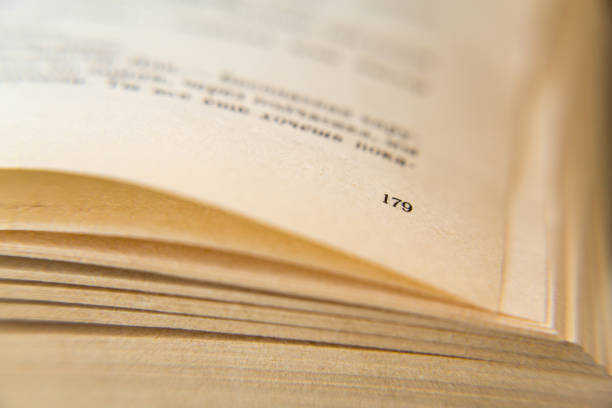 istock Open old book. Yellowed pages. Page number 179. Paper texture. Macro 824676888