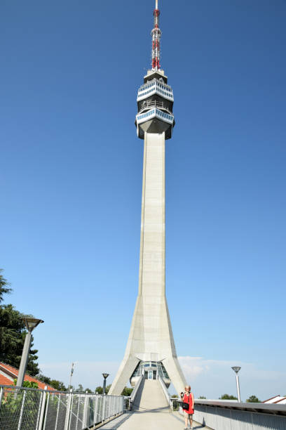 istock Female tourist in front of a modern white view tower 824677154