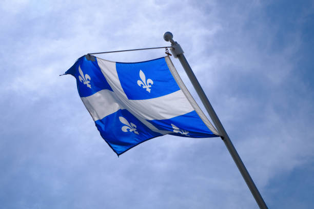 istock national Quebec flag in Canada fluttering in the wind on blue sky 824686896