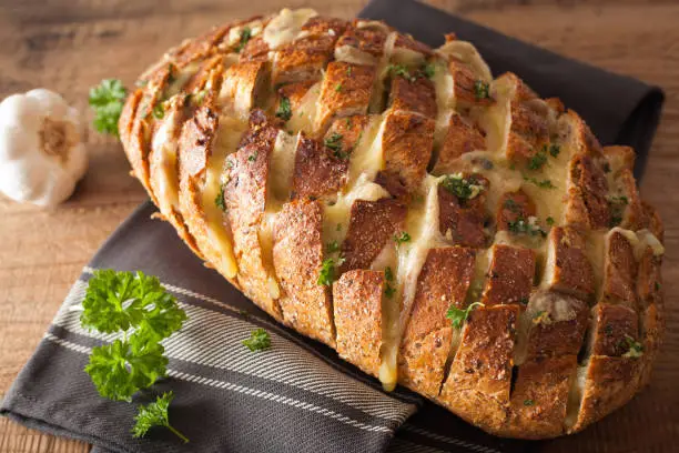 baked party bread with melted cheese butter herbs