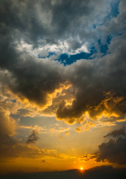 Cumulus clouds over the sunset stock photo