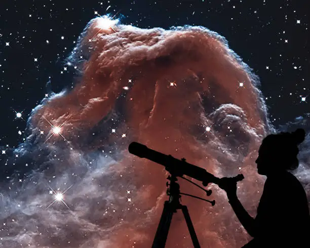 Girl looking at the stars with telescope. The Horsehead Nebula in the constellation of Orion (The Hunter)