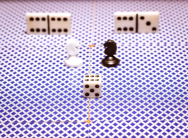 Photo of Chess dice and dominoes on playing cards