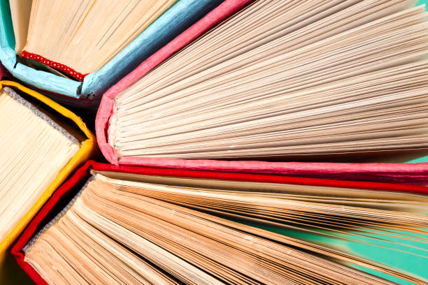 istock Top view of bright colorful hardback books in a circle. 824694008
