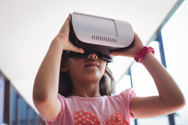 istock Low angle view of girl using virtual reality glasses against ceiling 824696994