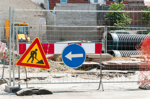 istock Closed construction site with protective fence, work signs and barrier. 824707008
