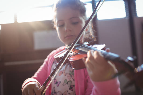 istock Girl student rehearsing violin 824709458