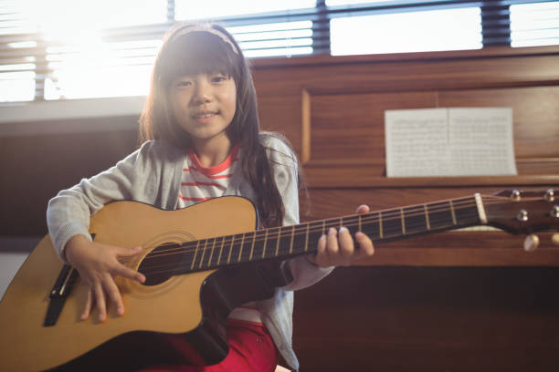 istock Portrait of girl practicing guitar 824710060