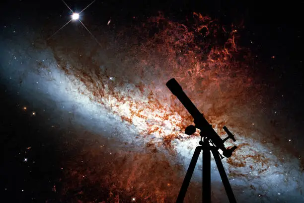 Space background with silhouette of telescope. Messier 82, Cigar Galaxy or M82 in the constellation Ursa Major