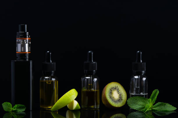 istock Green set of flavors for an electronic cigarette on a black background 824716806