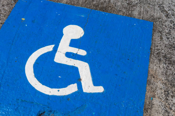 istock disabled blue parking sign painted on dark asphalt in Canada 824717106