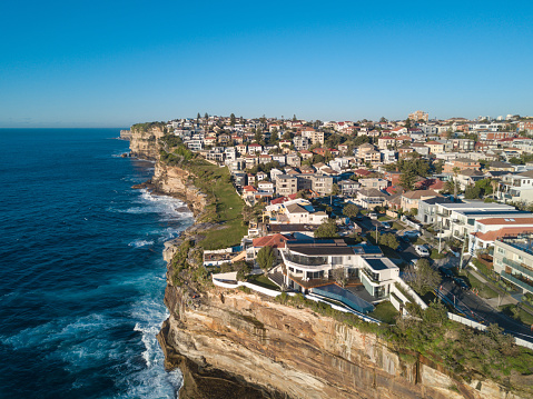 Aerial view of residential area across rock cliff area in Sydney coastline