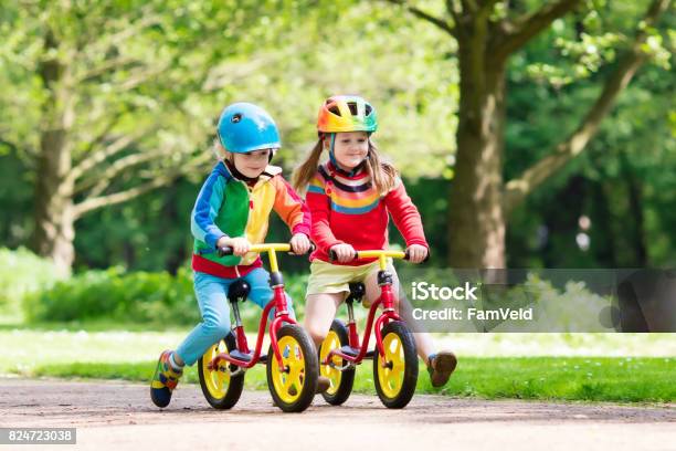 Kids Ride Balance Bike In Park Stock Photo - Download Image Now - Cycling, Bicycle, Child