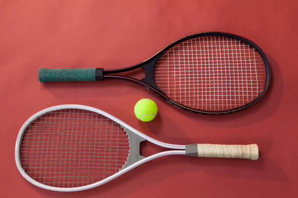 istock High angle view of ball amidst tennis rackets 824723874