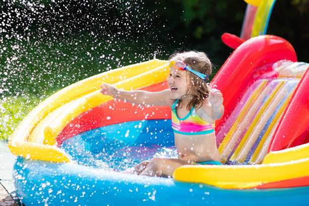 istock Child in garden swimming pool with slide 824726502