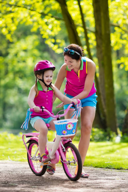 istock Mother teaching child to ride a bike 824726634