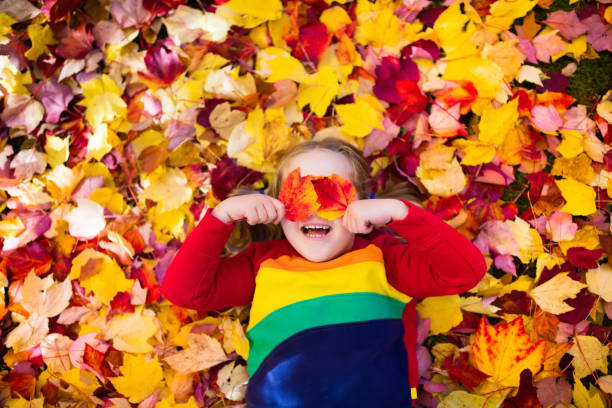 istock Child in fall park. Kid with autumn leaves. 824726646