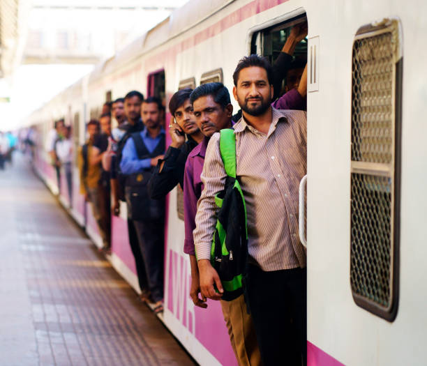 People travelling on local Indian train into Mumbai stock photo