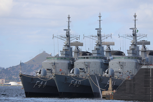 Three Canadian Navy mine-sweeping vessels are moored to a pier in Alaska