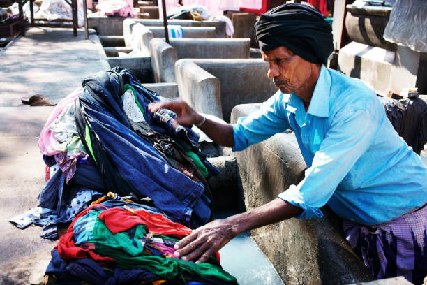Mumbai, India - January 27, 2017: Mumbai, India - January 12, 2016: Indian workers washing clothes at Dhobi Ghat, a well know open air laundromat in downtown of Mumbai, Maharashtra State。