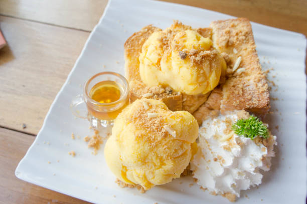 honey toast and ice cream on white dish wood table - cheesecake syrup almond cream imagens e fotografias de stock