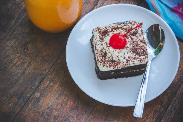 istock tasty chocolate cherry cake dessert on wood table 824750374