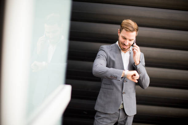 istock Successful businessmen entrepreneur using mobile phone  and look on watch 824753896