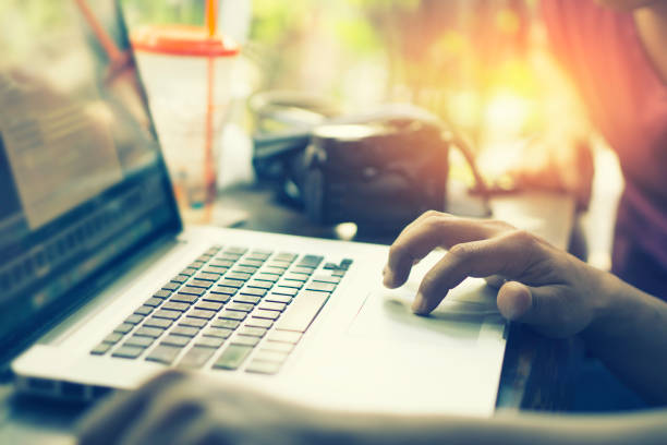 istock young business man keyboarding on laptop computer with blank copy space screen while sitting in cafe,finger on trackpad of computer,shot touching laptop trackpad,vintage color,selective focus 824757300