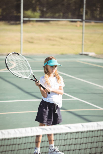istock Girl playing tennis during sunny day 824762926