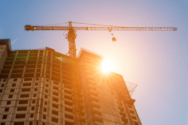 istock the construction crane and the building against the blue sky 824763718