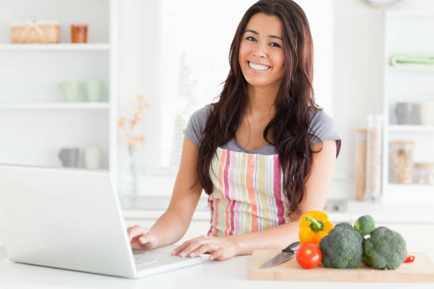 istock Beautiful woman relaxing with her laptop while standing 824763762