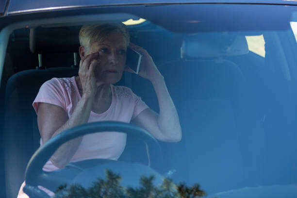 istock Senior woman talking on mobile phone in car 824766992