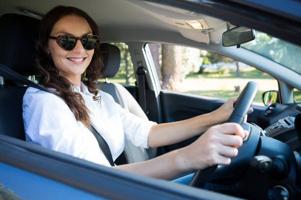 istock Beautiful woman driving a car 824767154